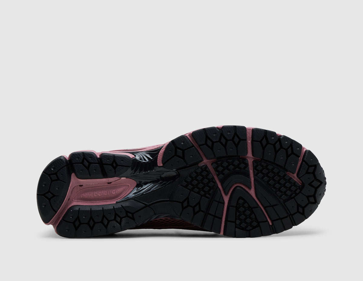 New Balance 1906L. Bottom view of single rosewood pink loafer showing black rubber outsole pattern with central stability arch shank. 