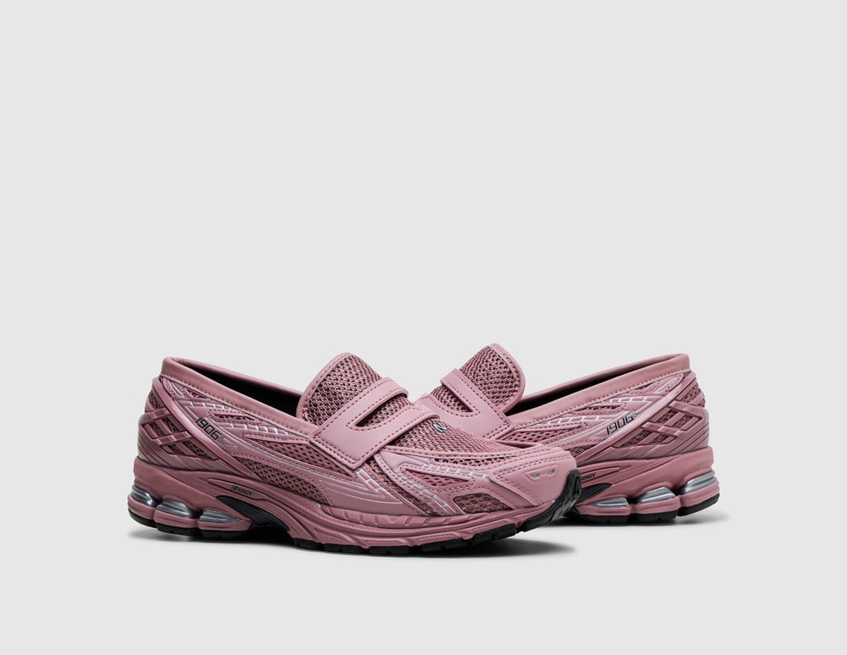 New Balance 1906L. Three-quarter view of pair of rosewood pink loafers showing open mesh base, penny loafer strap design, and segmented midsole. 