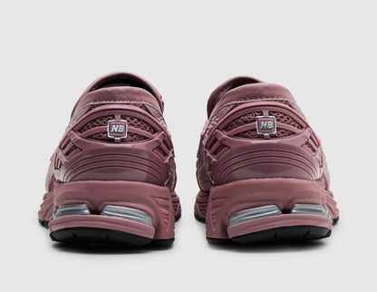 New Balance 1906L. Rear view of pair of rosewood pink loafers showing TPU heel counter cages, NB logos, and visible N-ergy heel cushioning pods. 