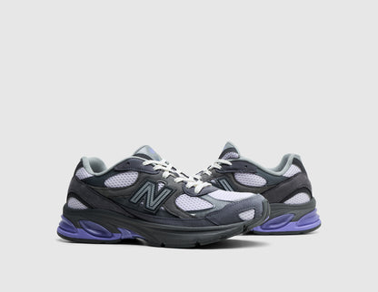 New Balance ABZORB 2010. Three-quarter view of pair of neptune grey running shoes showing light grey mesh panels, white laces, and violet crush heel accents. 