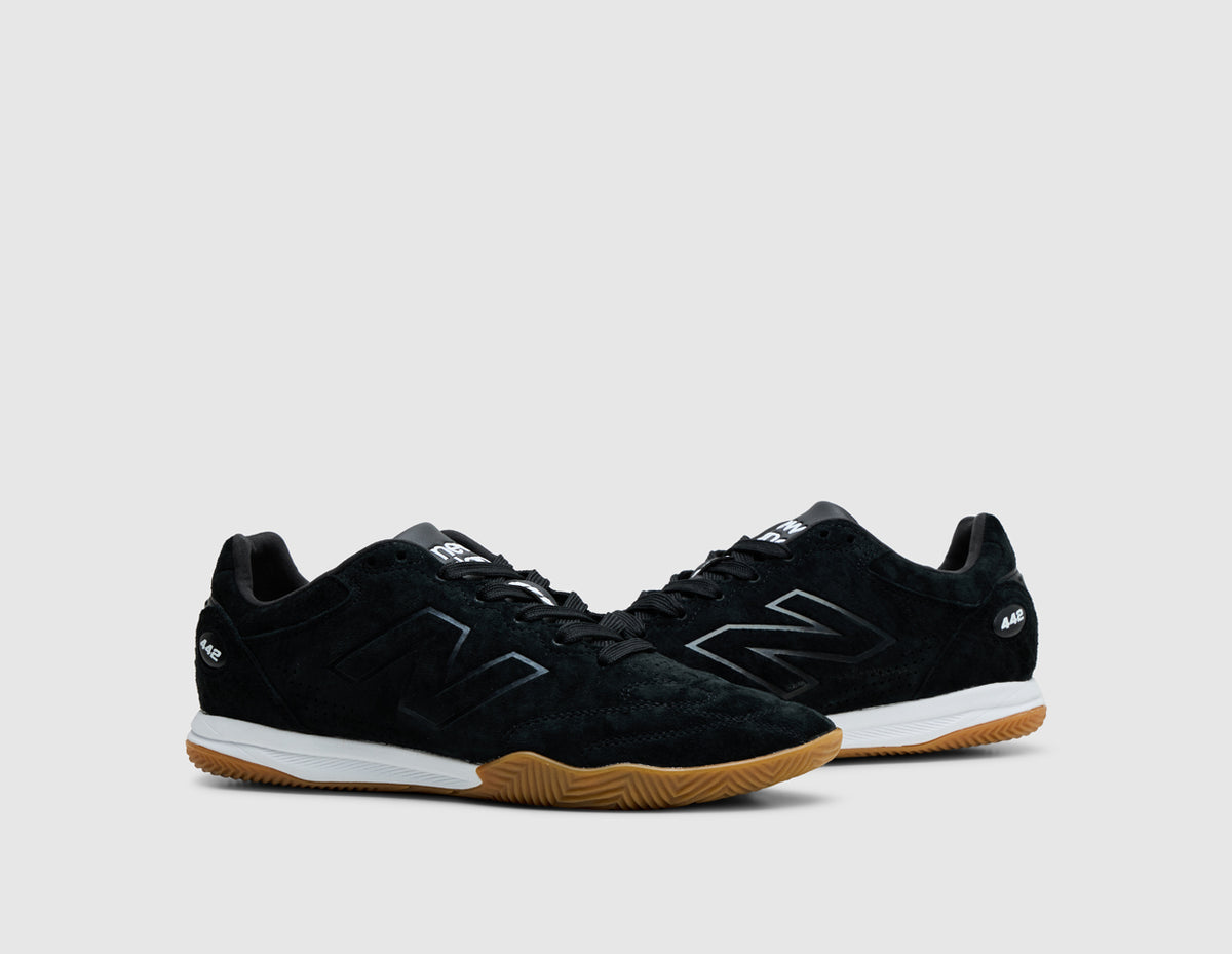 New Balance 442 Elite IN LS V3. Three-quarter view of pair of black sneakers showing black suede upper, tonal laces, and gum rubber outsole. 