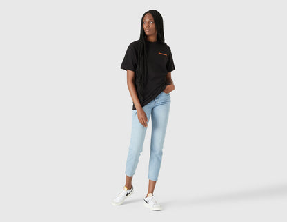 size? Vancouver Logo T-Shirt. Full-length model view of female model styled in the black shortsleeve t-shirt. 