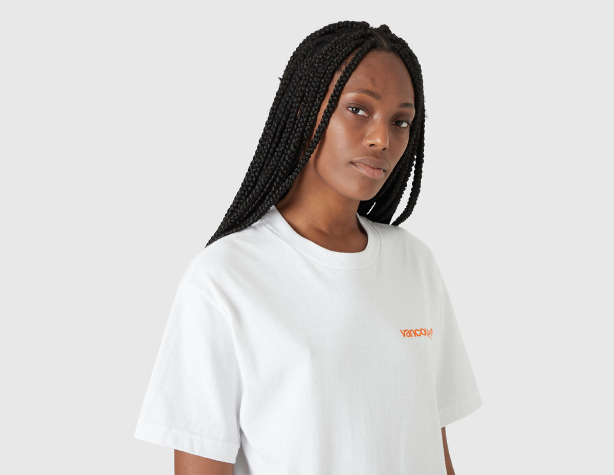 size? Vancouver Logo T-Shirt. Half-length portrait model view of female model wearing the white t-shirt with orange chest logo. 