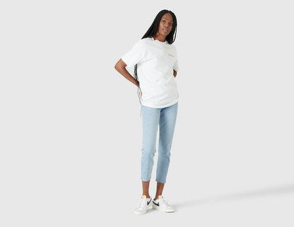 size? Vancouver Logo T-Shirt. Full-length model view of female model styled in the white shortsleeve t-shirt. 
