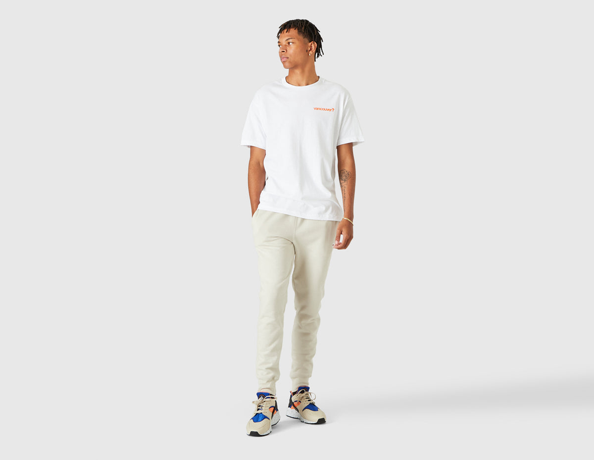 size? Vancouver Logo T-Shirt. Full-length model view of male model styled in the white shortsleeve t-shirt. 