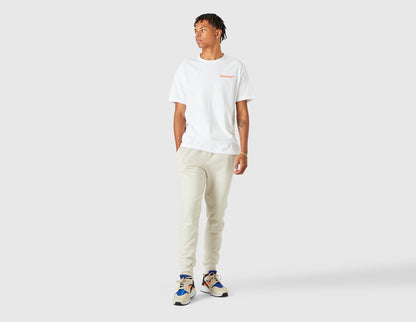size? Vancouver Logo T-Shirt. Full-length model view of male model styled in the white shortsleeve t-shirt. 