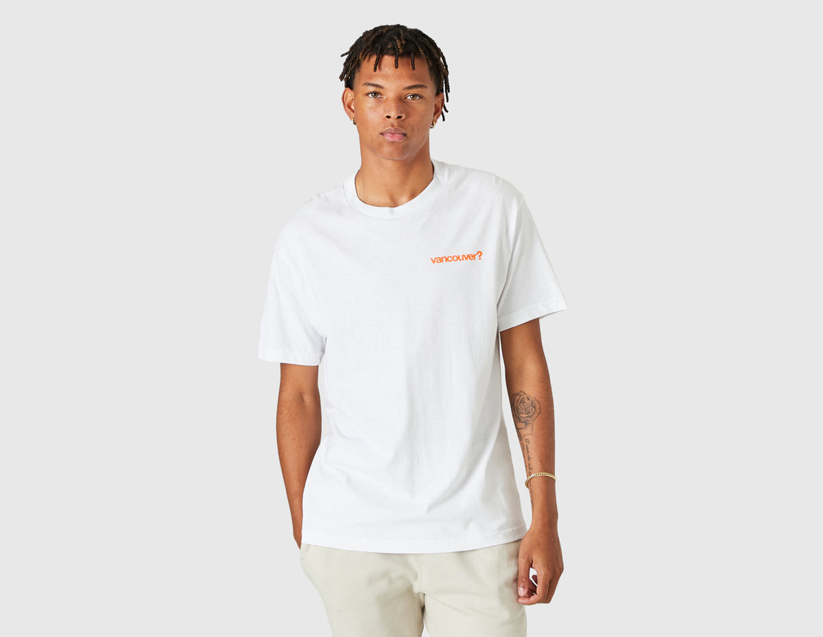 size? Vancouver Logo T-Shirt. Front model view of white shortsleeve t-shirt featuring a crewneck collar and orange printed "vancouver?" text logo on the left chest. 