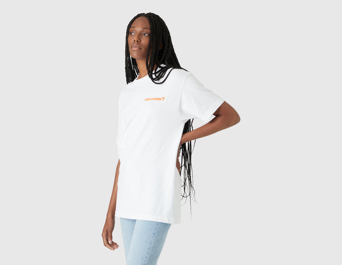 size? Vancouver Logo T-Shirt. Three-quarter model view of female model wearing the white shortsleeve t-shirt with orange left chest logo.